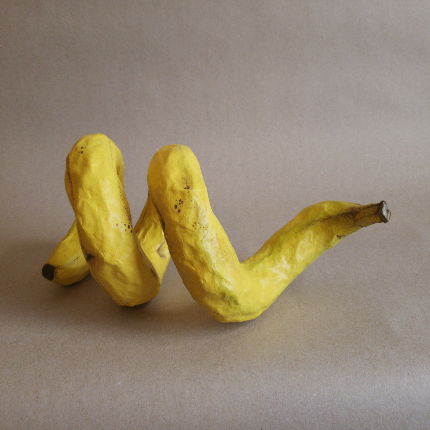 Curly Banana | 19x8x8in, papier mache sculpture with acrylic paint, 2025.